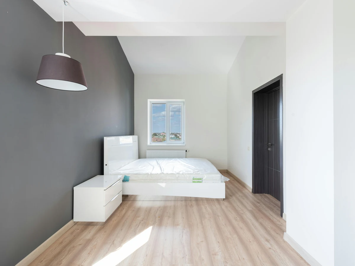 Minimalist dark bedroom painted with professional finish by Bridgend Decorators